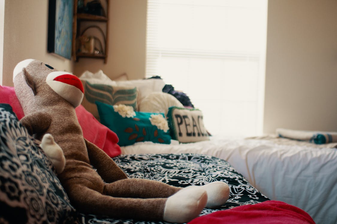 Free Plush toy placed on couch in bedroom Stock Photo