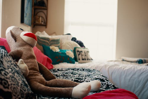 Free Plush toy placed on couch in bedroom Stock Photo