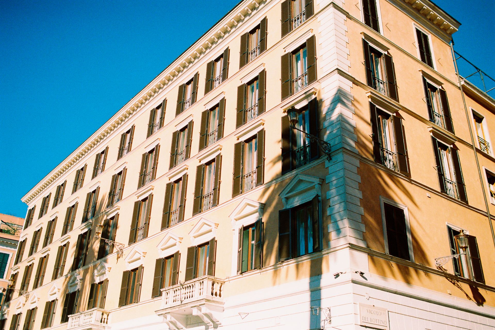 Shadows of Palm Trees on the Facade of a Building in Piazza di Spagna in Rome