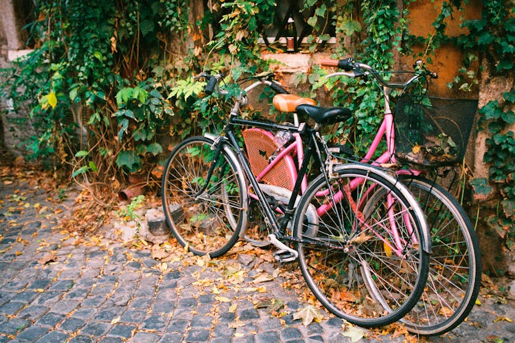 Bicycles Leaning On A Side Wall Of A House 