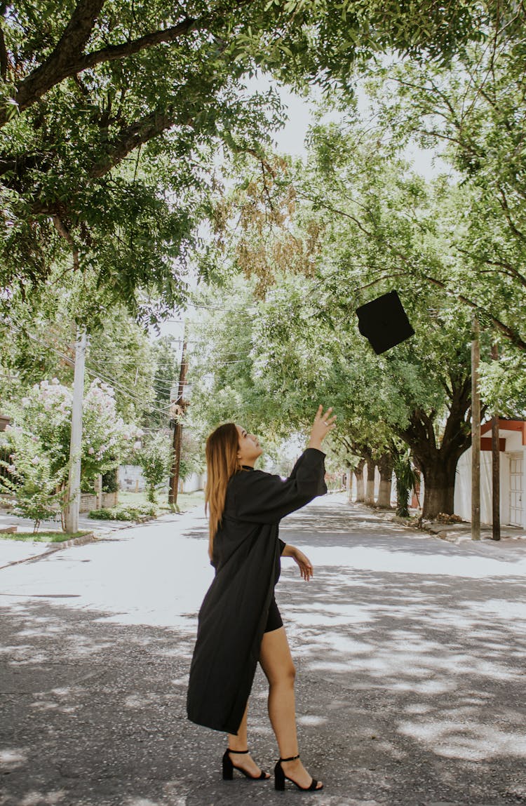 Concentrated Woman Throwing Cap In Air