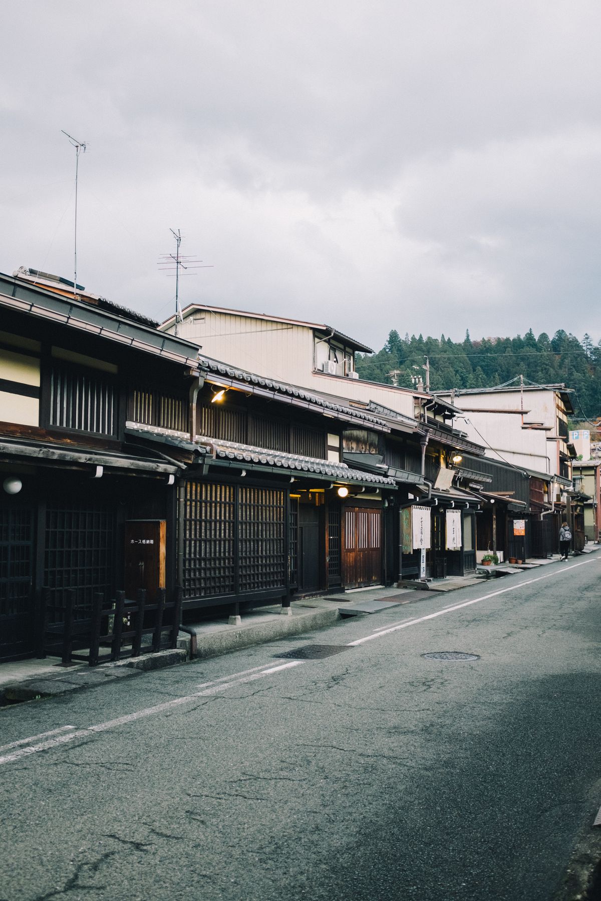 Traditional Japanese village street with wooden houses and tiled roofs — illustrative of an old preserved post town like Ouchi-juku