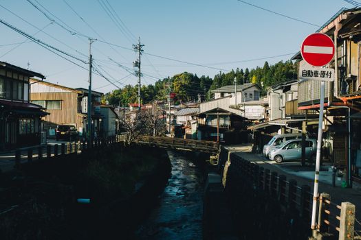 阳光明媚，日本的城市景观迷人，有运河、传统房屋和电线