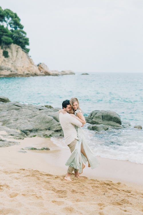 A Man Carrying a Woman at the Beach