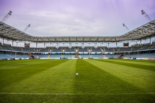 Explore a soccer stadium with clear skies and pristine grass, perfect for any sports event.