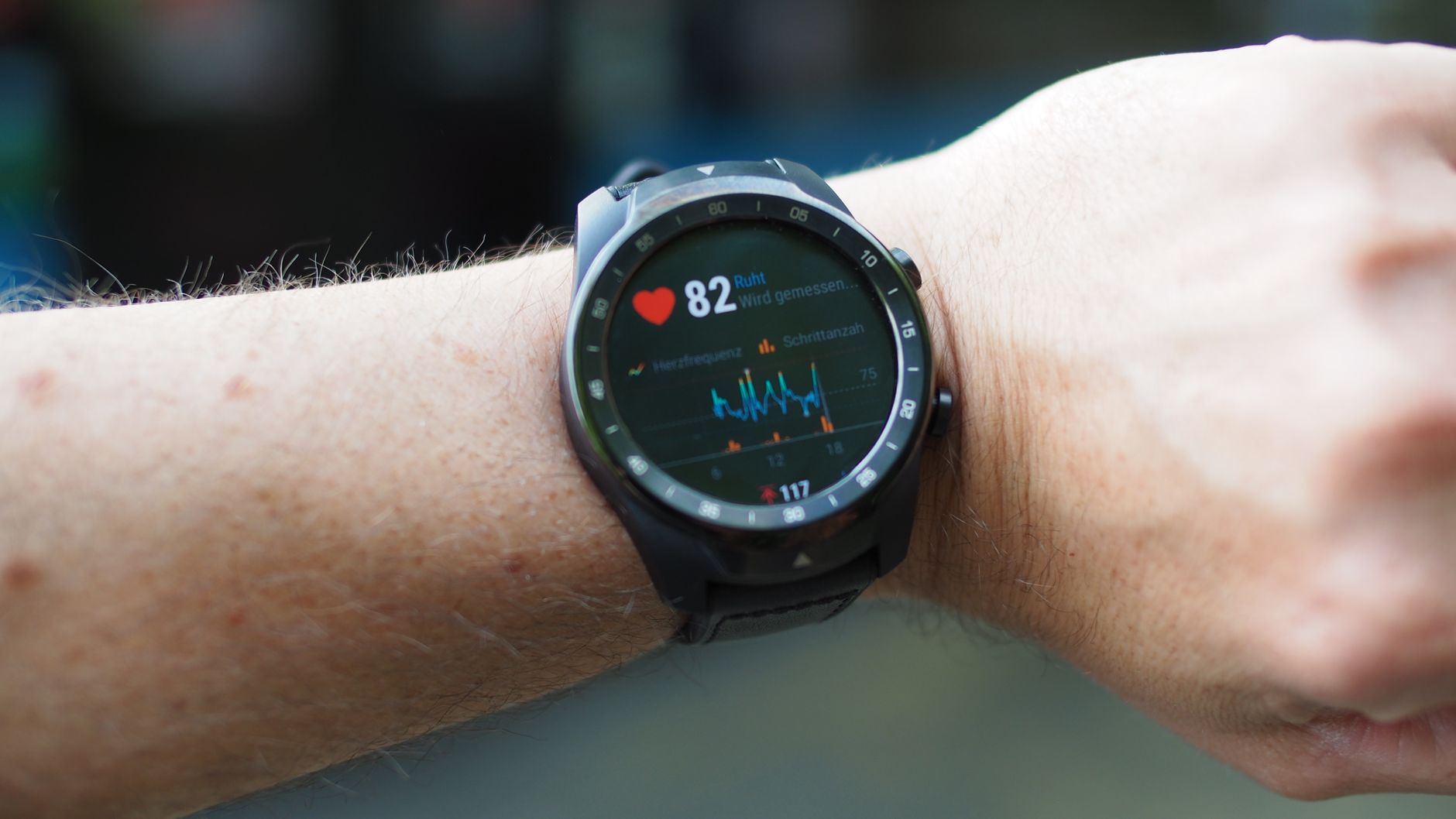 Close-up of smartwatch displaying heart rate and SpO2 readings