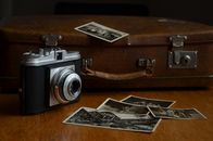 Black and Gray Camera Beside Photos