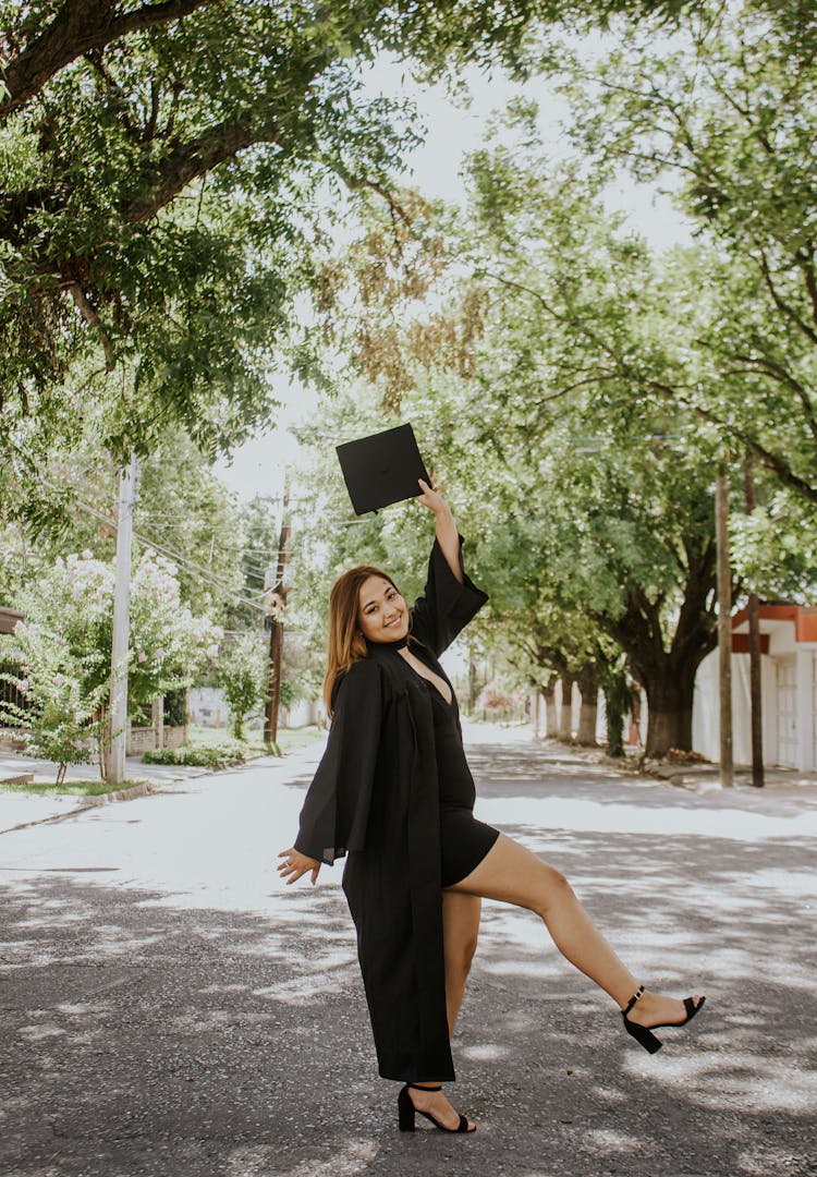 Excited Woman With Cap In Hand