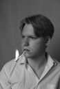 Man holding burning stick in mouth