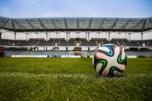 Soccer Ball on Grass Field during Daytime