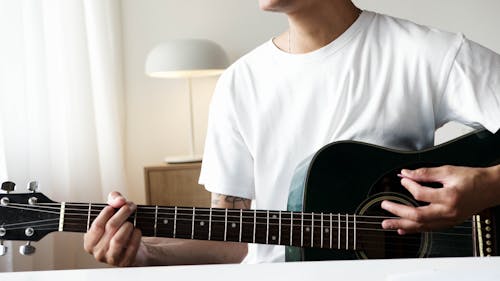 Free Man in White Shirt Playing Guitar Stock Photo