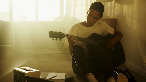 Man in White Crew Neck T-shirt Playing Acoustic Guitar
