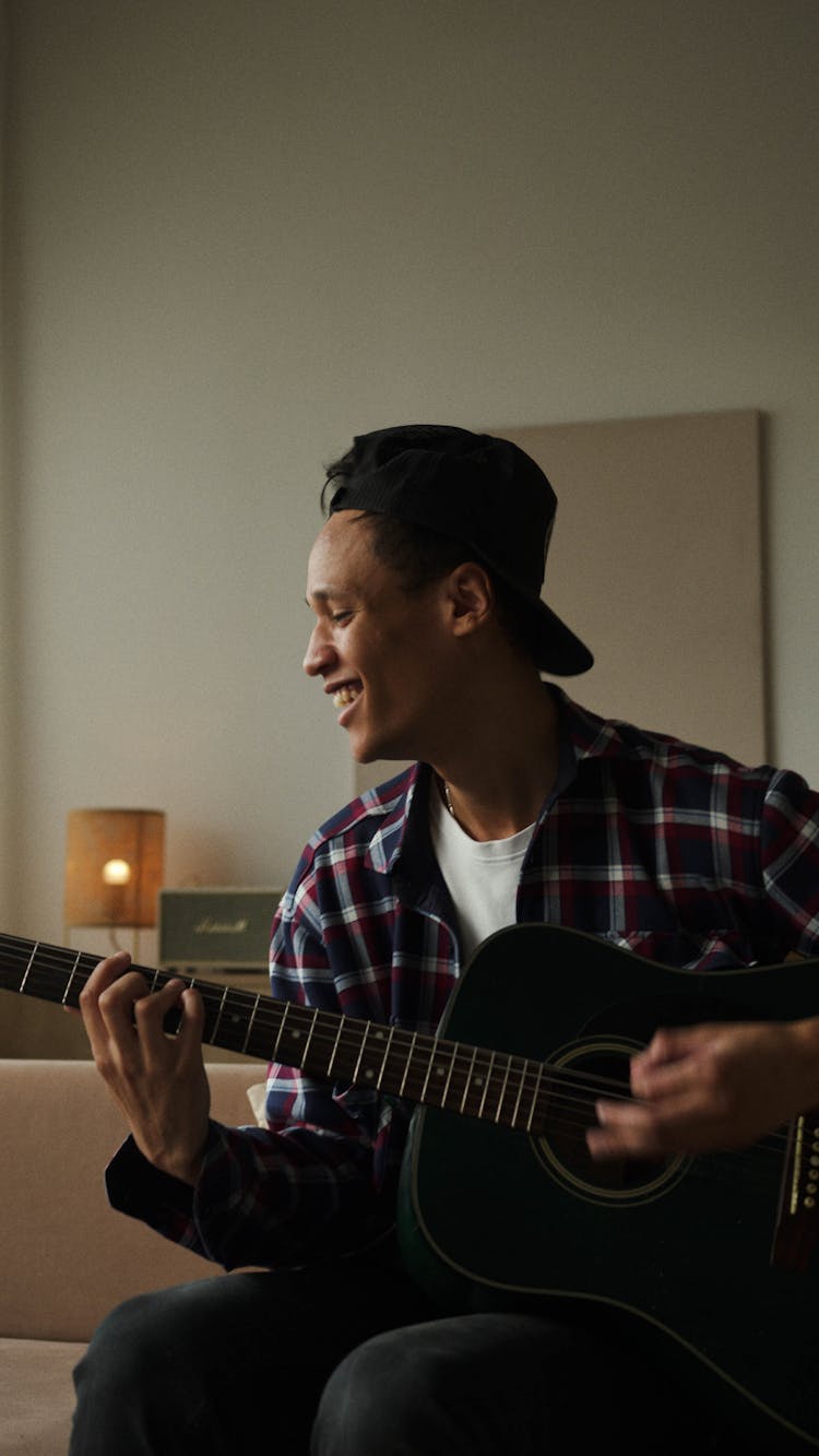 Smiling Man Playing The Guitar