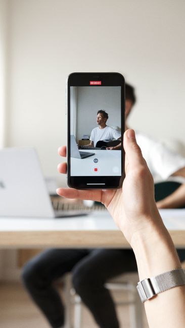 Close-up of recording music on a smartphone indoors.