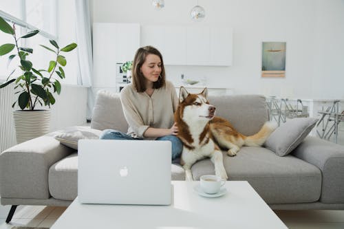 Woman Sitting with Dog in Room