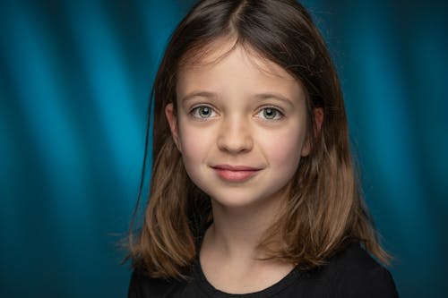 Calm girl with brown hair looking at camera