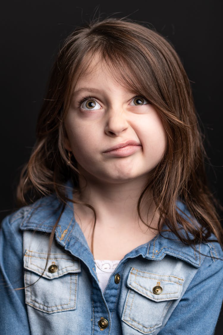 Confused Young Girl In Denim Shirt