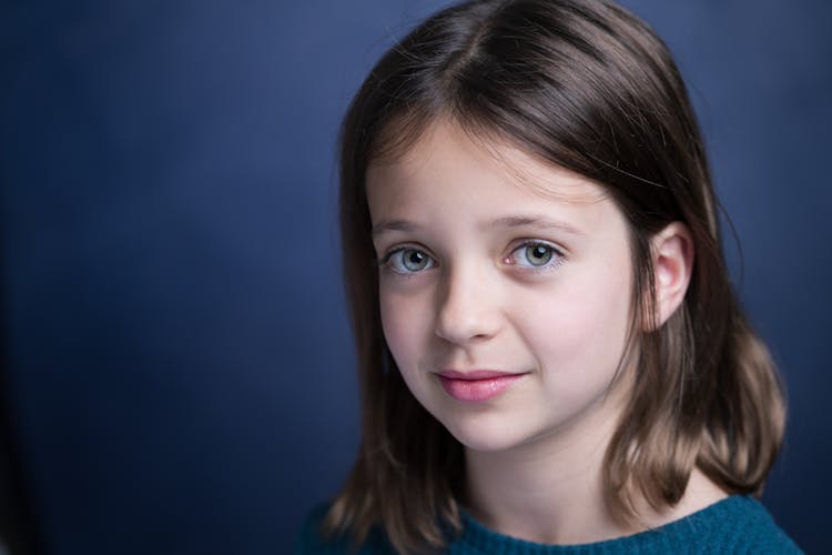 Girl With Brown Hair In Blue Sweater