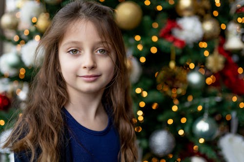Free Girl with long curly hair near Christmas tree Stock Photo