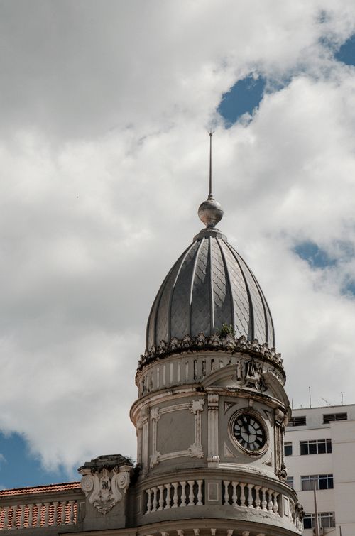 Free A detailed view of a historic clock tower against a cloudy sky in Juiz de Fora, Brazil. Stock Photo