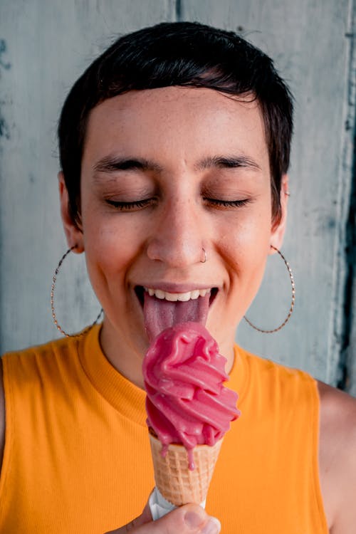 Woman Eating Ice Cream Cone With Closed Eyes