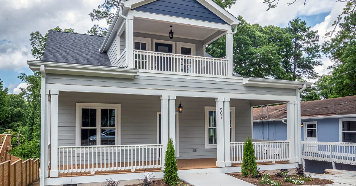 A beautiful suburban home featuring classic architecture and a well-maintained front yard.
