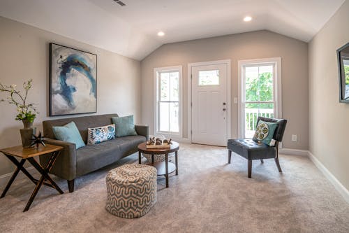 Beige Living Room With Gray Sofa and Easy Chair