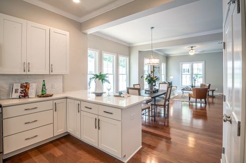 Kitchen with white wooden cabinets in a well kept Louisville home