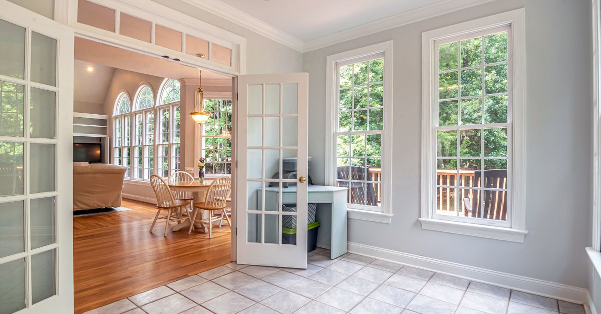 An empty condo living room with large windows, showing the choices facing pre construction condo buyers