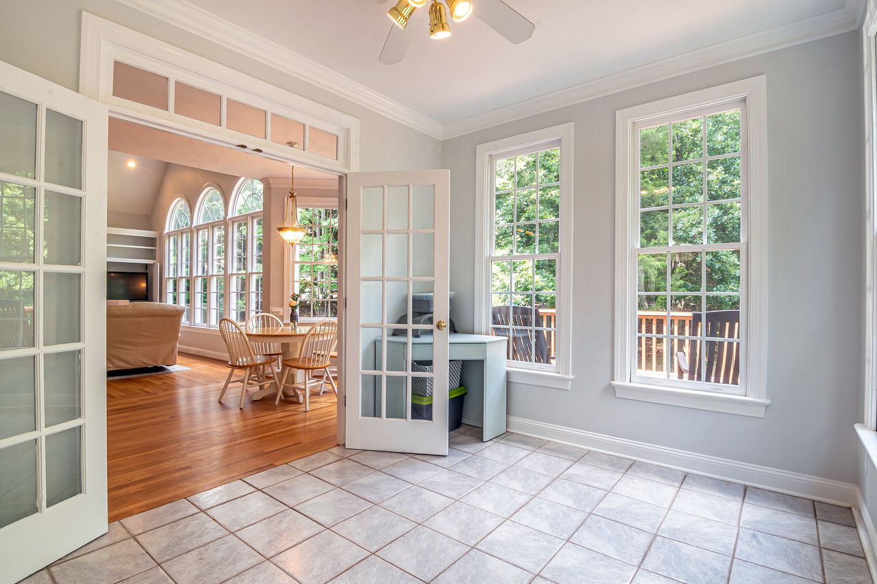 Bright living and dining area with open glazed double doors and garden views