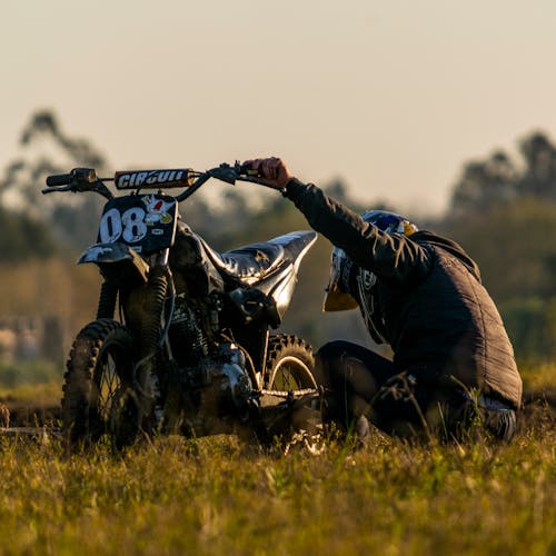 Motorcyclist Holding Motorcycle