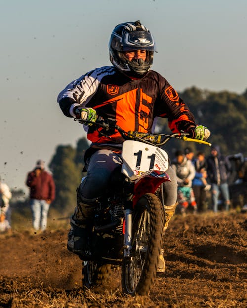 Man in Red and Black Motorcycle Suit Riding Motocross Dirt Bike