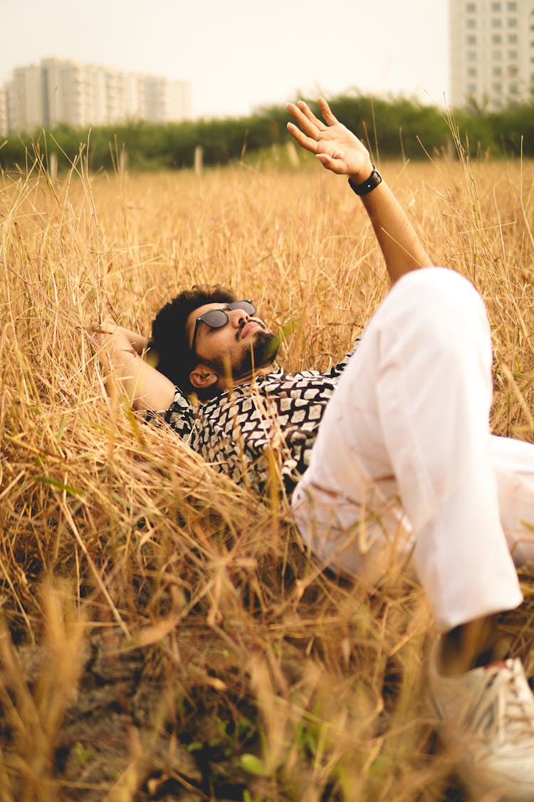 Stylish Calm Man Lying On Grass In Park