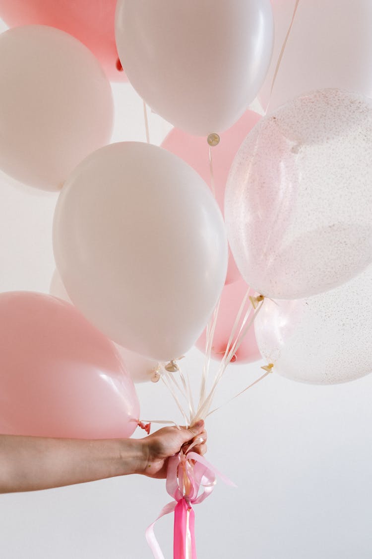 Bouquet Of Pink Balloons Held By A Person 