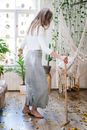 Woman in White Long Sleeve Dress Standing on Brown Wooden Ladder