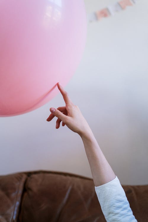 Person Holding Pink Balloon