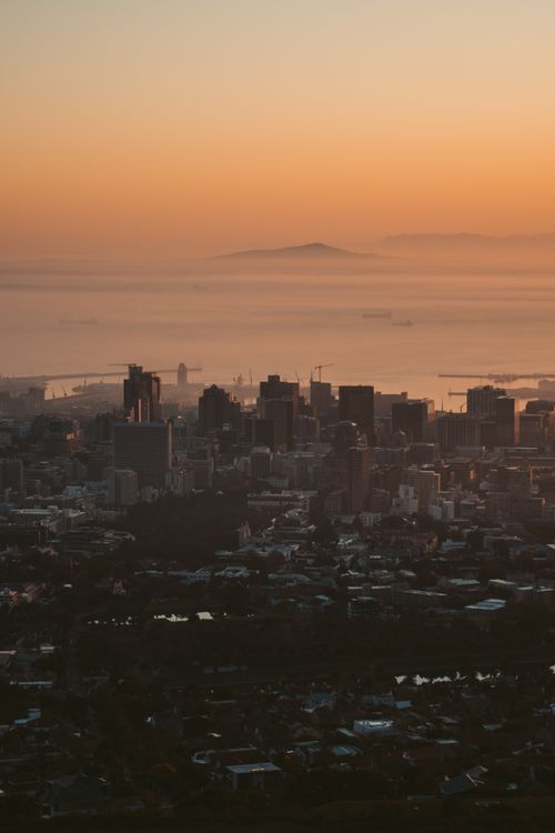 Free Stunning aerial cityscape with misty sunrise and glowing skyline. Stock Photo