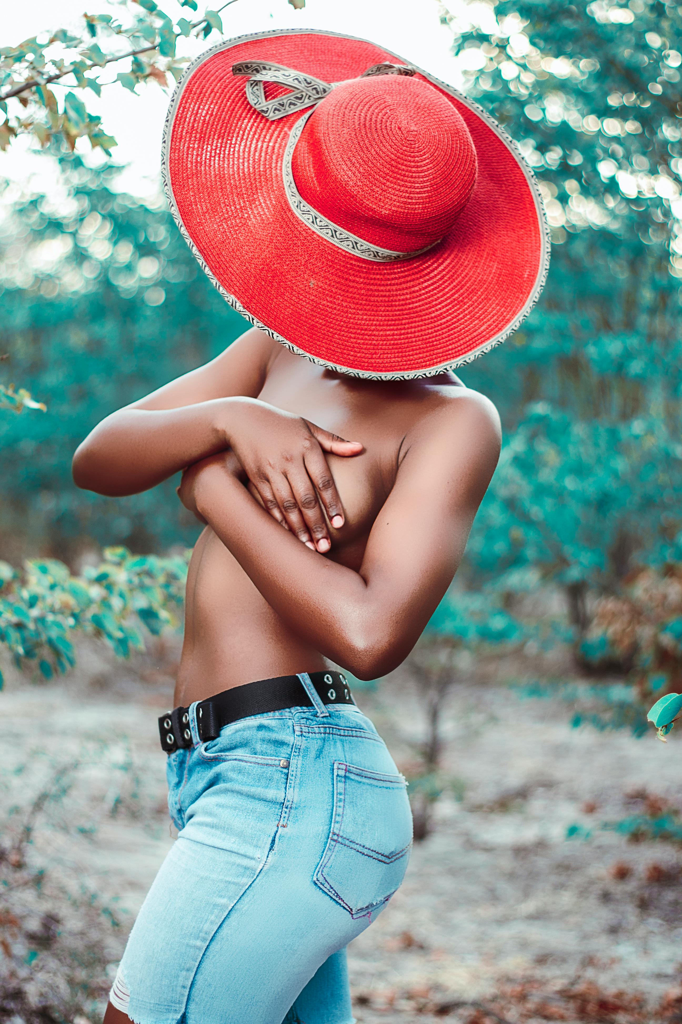 Black woman covering bare breast with hands · Free Stock Photo