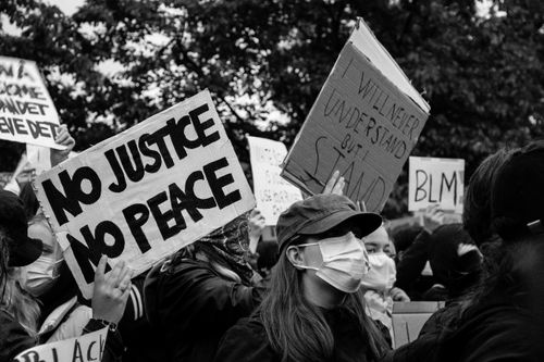 Free Monochrome image of a Black Lives Matter protest in Oslo, showcasing placards and face masks. Stock Photo