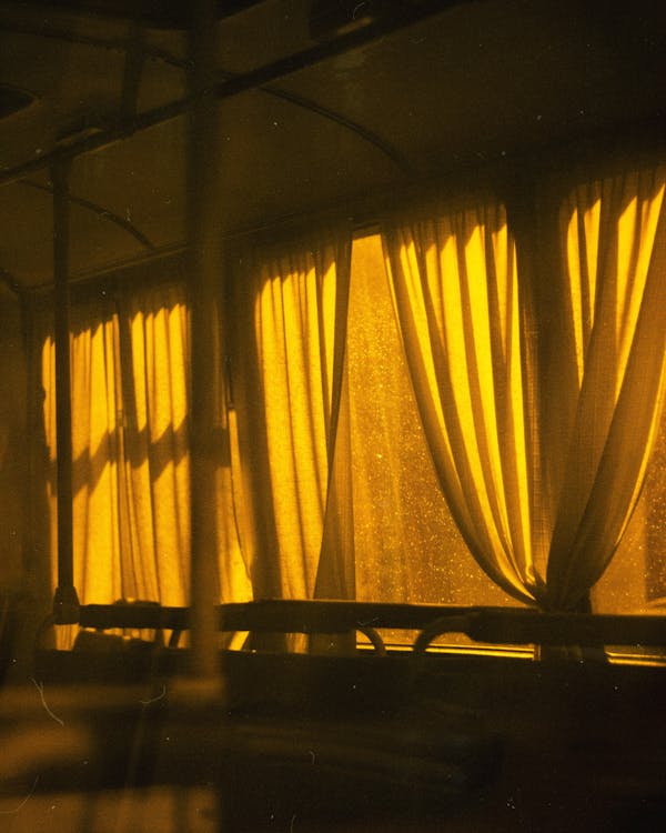 Free Yellow Curtains in a Dark Room Stock Photo