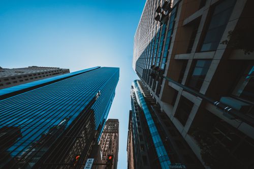 Free From below of contemporary multistage building facades near traffic lights in town under sky Stock Photo