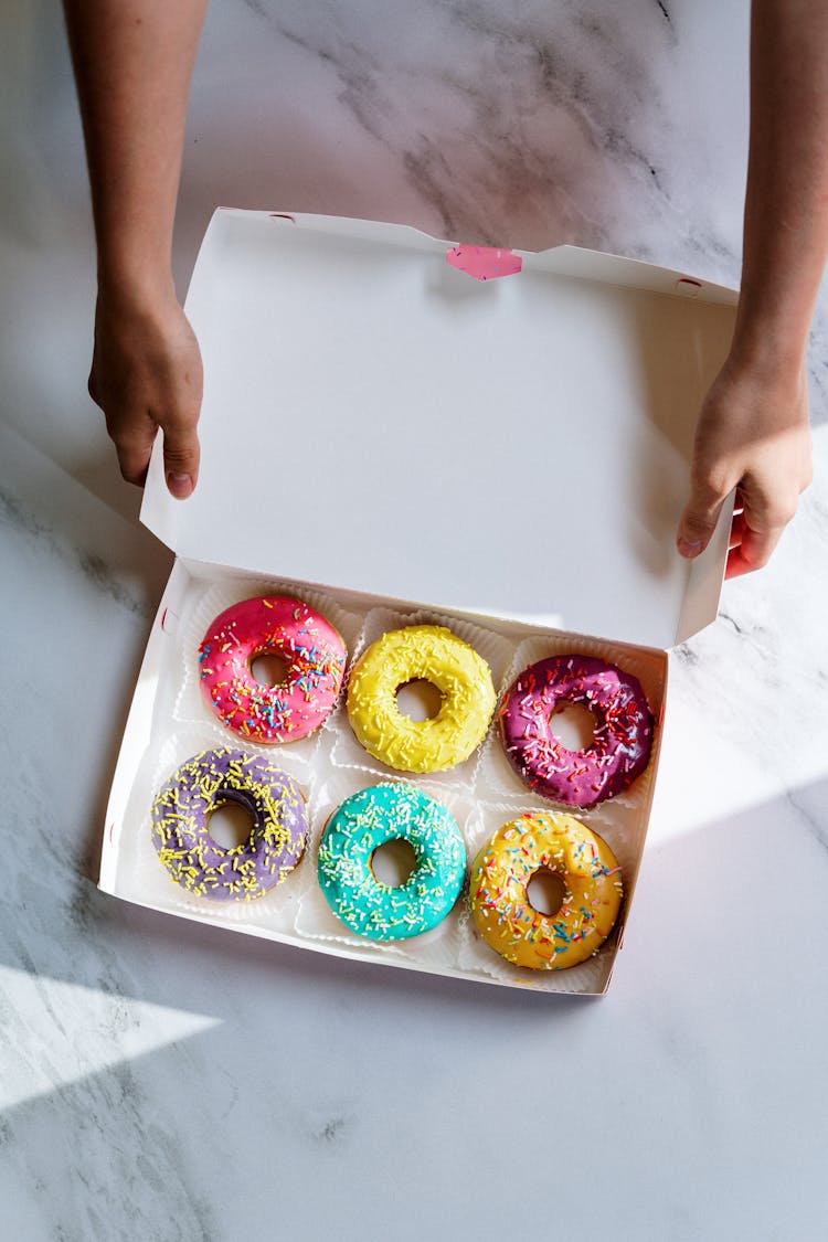 Photo Of Person Holding Box Of Doughnuts