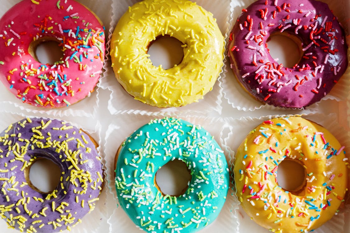 Free Pink Doughnut on White Textile Stock Photo