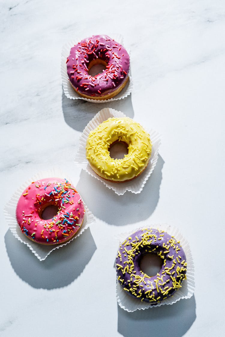 Two Pink And Brown Doughnuts