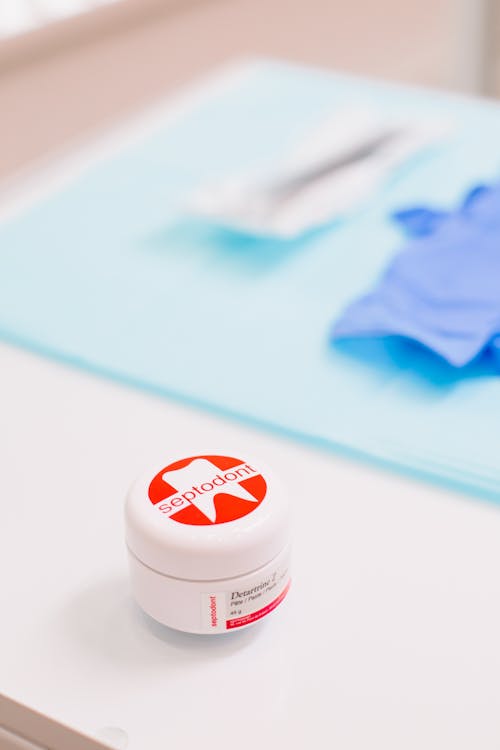 Dental Medicine in White and Red Plastic Container