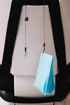 Dental bib holder with blue bib in a clinical setting, promoting dental hygiene.