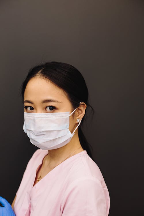 A Woman in Pink Scrub Suit Wearing Face Mask