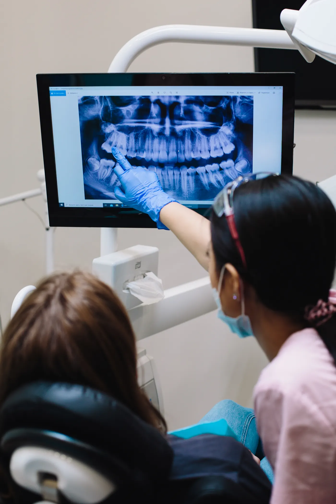 Dentist explaining a dental X-ray to a patient