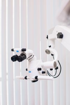 Detailed view of a sophisticated dental microscope used in clinical settings, highlighting advanced technology.