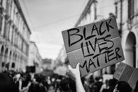 Grayscale Photo of a Person Holding a Placard with Sign Black Lives Matter